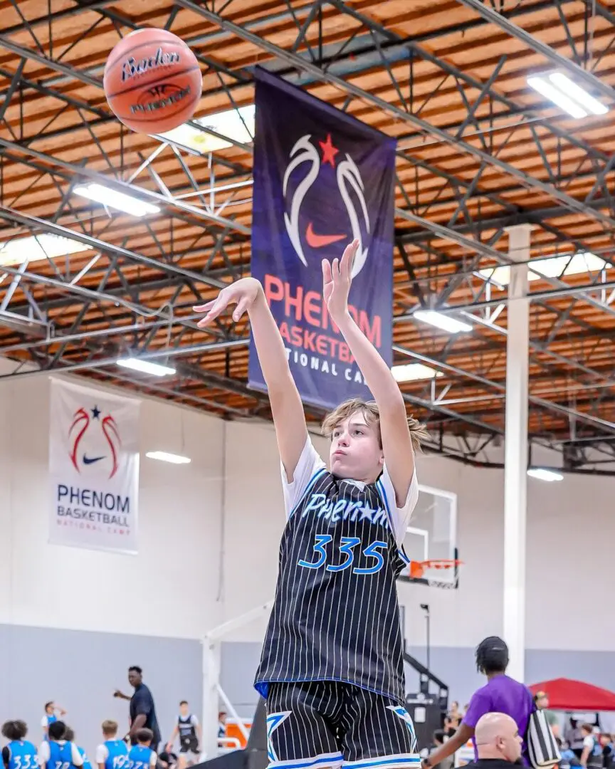 Boy shoots basketball at Phenom camp.