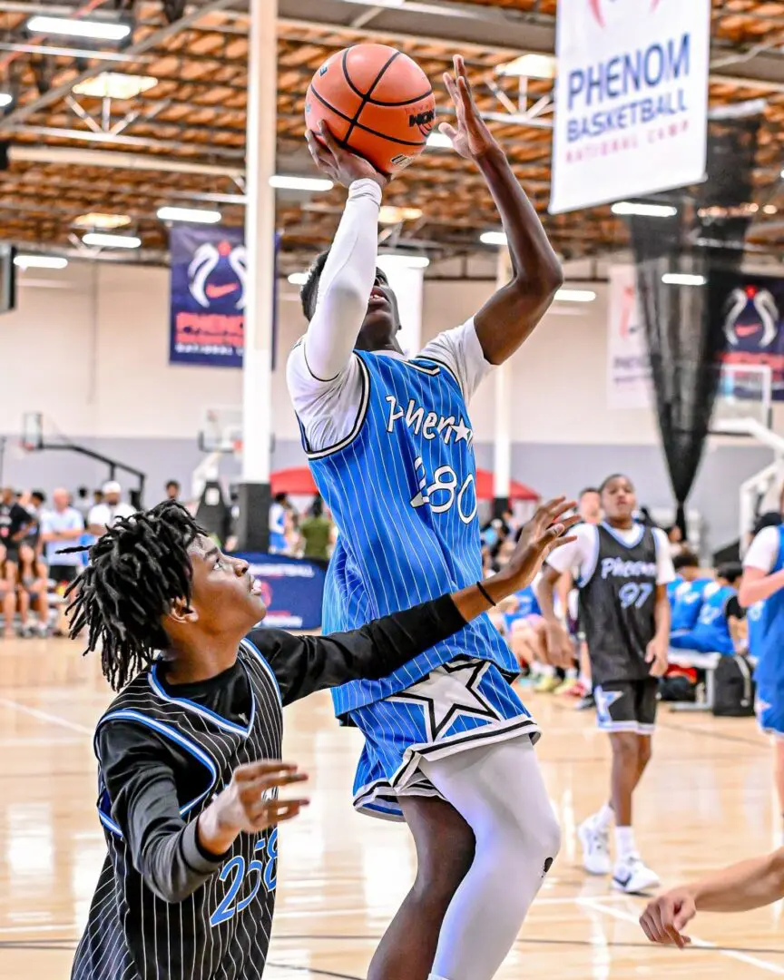 Basketball player shooting hoops in game.