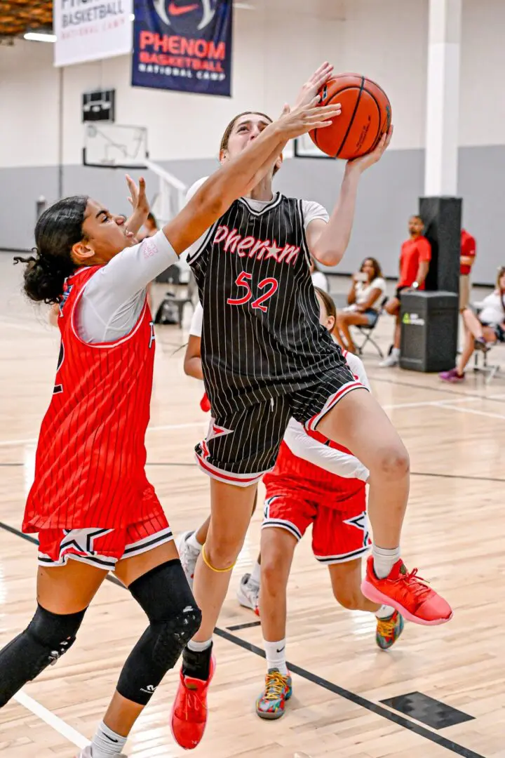 Girls playing basketball, intense game.